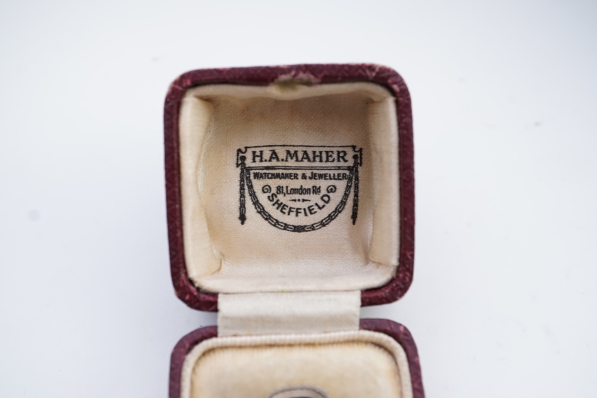 A diamond and blue glass ring